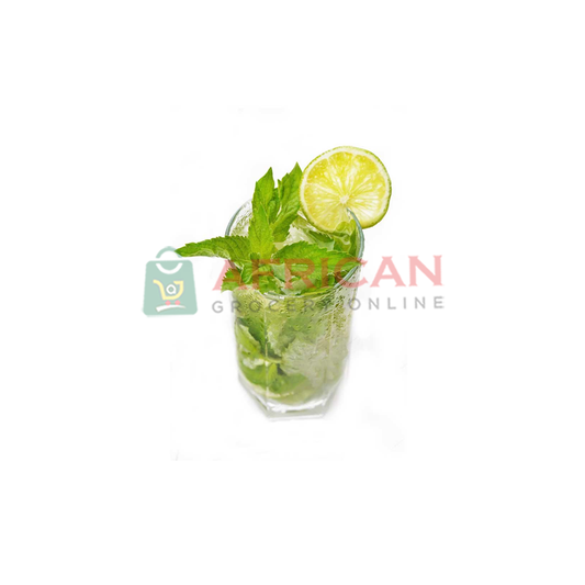 A glass of lime juice with a slice of lime and a sprig of mint, garnished with a lemon wedge and a sprig of mint, against a white background.