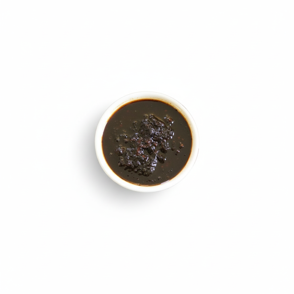 A cup of Shito (Chili Pepper Source) with the Africon logo visible on the side.