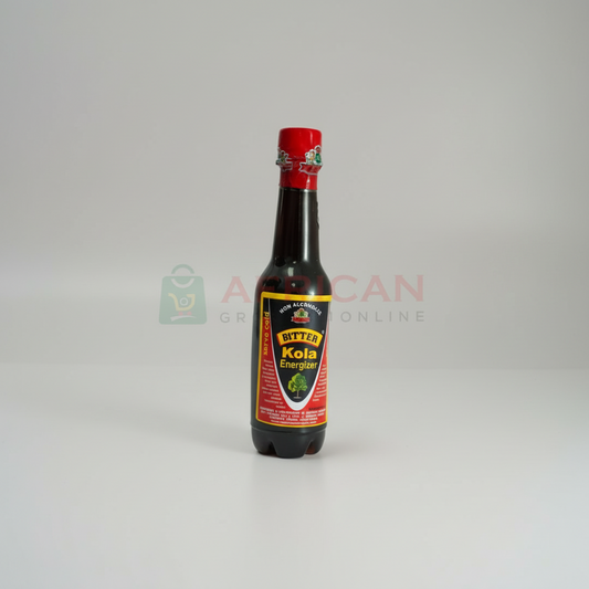 A bottle of BITTER KOLA KADCO with a red cap on a white background, labeled with the product name and a website address.