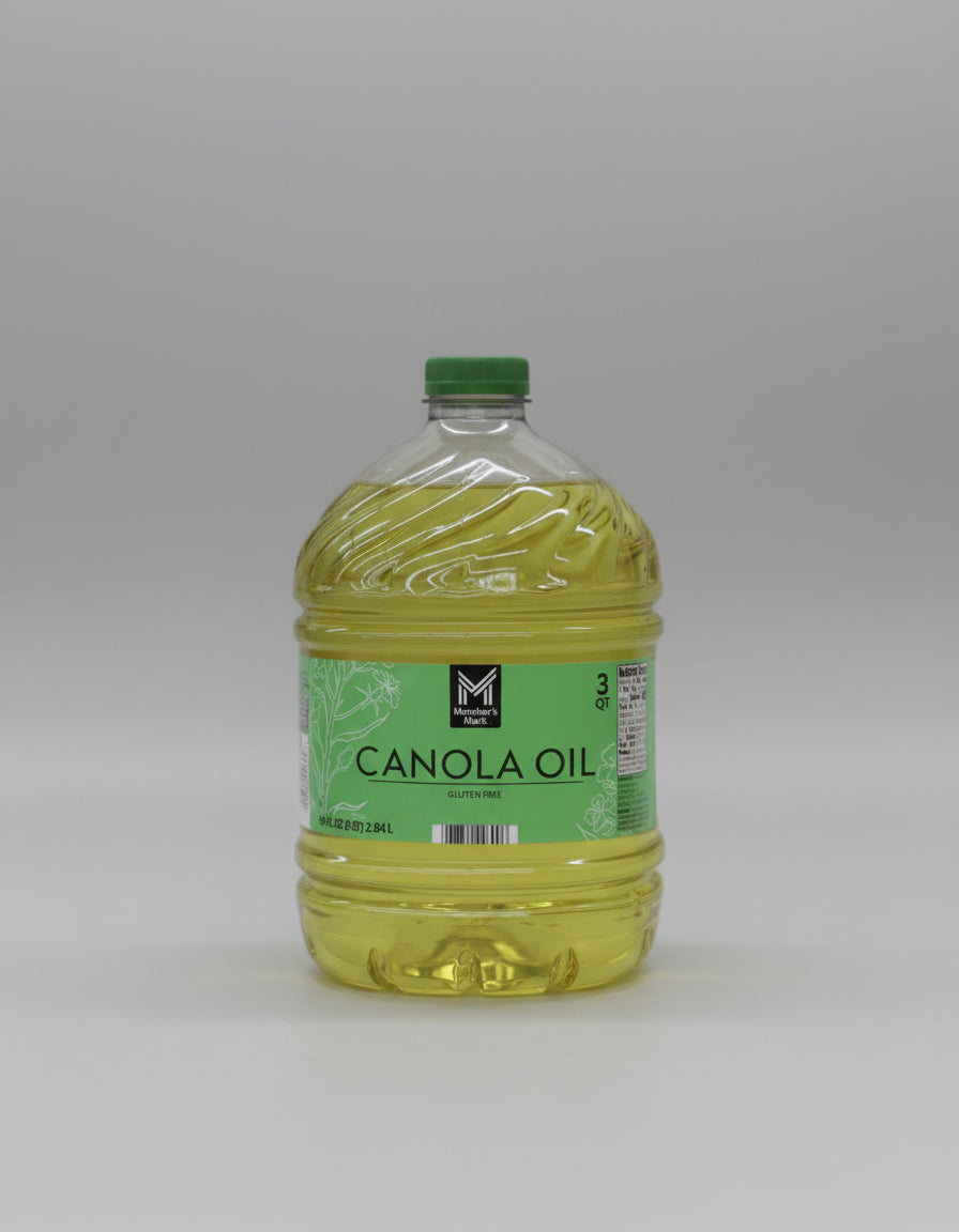 Bottle of canola oil with a green label on a white background