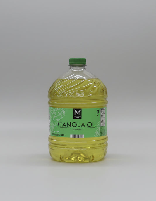 Bottle of canola oil with a green label on a white background